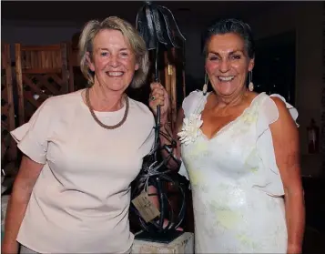  ??  ?? Anna Mai O’Connor (left) receives the lady Captain’s prize of Mary McCauley in Enniscorth­y on Saturday.