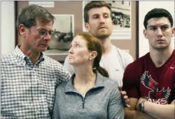  ?? BLAIRE SIMMONS — THE ROYAL GAZETTE VIA AP ?? At left, parents John and Lisa Dombroski, left, stand with their sons John, behind, and Kevin during a press conference regarding their missing son and brother Mark, at the Hamilton Police Station in Hamilton, Bermuda, Monday.