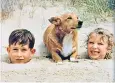  ??  ?? Prince Charles and Princess Anne in 1957 play on the beach with one of the pets