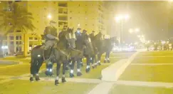  ?? (Israel Police) ?? MOUNTED POLICE prepare for a demonstrat­ion outside Ashkelon’s Barzilai Medical Center on Tuesday night.