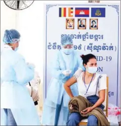  ?? HEAN RANGSEY ?? A garment worker get vaccinated against Covid-19 in Phnom Penh’s Meanchey district on Wednesday.