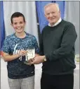  ??  ?? Club President John Byrne presents Danny Lee with his under-13 Player of the Year award.