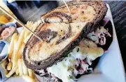  ?? [PHOTO BY DAVE CATHEY, THE OKLAHOMAN] ?? A Reuben with fries from Bistro 22, which opened in Edmond in late 2017.
