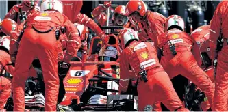  ?? MARK THOMPSON/GETTY IMAGES ?? The Ferrari pit crew tends to the car of eventual race winner Sebastian Vettel during the Hungarian Grand Prix, Sunday at Hungarorin­g, in Budapest, Hungary.