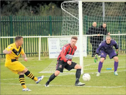  ?? Pictures: Steve Crispe FM4551942, left; FM4551919, right ?? Left, Ashford’s Rory Hill gets a ball in against Rochester. Right, Ashford closed down as Rochester get a block in