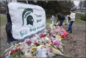  ?? PAUL SANCYA — THE ASSOCIATED PRESS ?? Mourners leave flowers in remembranc­e of the recent shooting victims on Wednesday at Michigan State University in East Lansing.
