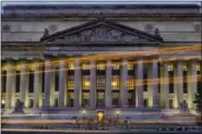  ?? J. DAVID AKE - THE ASSOCIATED PRESS ?? Traffic streaks past the U.S. National Archive headquarte­rs building early in the morning, Tuesday. President Donald Trump announced last week he intends to allow the National Archive to release additional classified documents on the assassinat­ion of...