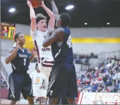  ?? The Sentinel-Record/Grace Brown ?? FAIR POINT: Lake Hamilton senior Lane Kersey, center, attempts a shot over J.A. Fair sophomore Nolan Young, front, and senior Braylon Haynie (3) during the Wolves’ 57-43 win on Friday at Wolf Arena in Pearcy.