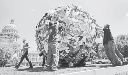  ?? Eric Gay / Associated Press file ?? Outside the state’s capitol, Texans are reminded of the meaning behind a 30-year-old slogan. A ball of trash was used as a prop by the Texas Department of Transporta­tion to launch new announceme­nts as part of the “Don’t Mess with Texas” anti-litter...