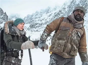  ??  ?? Kate Winslet stars as a journalist trying to get to her wedding and Idris Elba plays an in-demand surgeon. They have to trek through miles of snow-covered wilderness to be rescued.