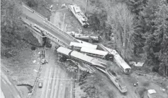  ?? JOHN FROSCHAUER/AP ?? Cars from a derailed Amtrak train spilled onto Interstate 5 on Monday.