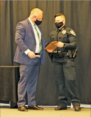  ?? ELISHA MORRISON/ The Saline Courier ?? Officer
Kaitlyn Fleetwood has been selected as the first female
SWAT team member of the Benton Police Department. Here, Fleetwood receives a plaque from BNPD Chief Scotty Hodges for being named Officer of the Year in a February ceremony. She also received the Life Saving Award before Hodges surprised her by officially naming her to the SWAT team.