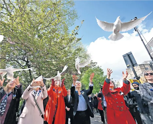  ?? ?? Friends and former colleagues of WPC Yvonne Fletcher release doves at the spot in London where she was gunned down by someone shooting from a window of the Libyan embassy