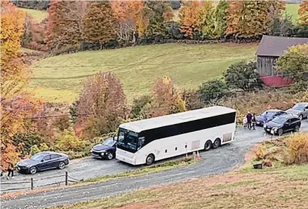  ?? Associated Press ?? A tour bus and cars crowd a narrow road that has become a destinatio­n for fall foliage viewers in Pomfret, Vermont. The town is closing the road to leaf peepers through mid-October because of issues including safety and quality of life concerns.