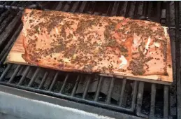  ?? JAN UEBELHERR / FOR THE MILWAUKEE JOURNAL SENTINEL ?? Grilling salmon on a cedar plank adds smoky flavor to the fillet.