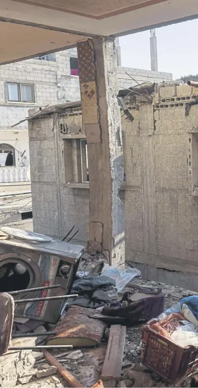  ?? ?? A child looks through the window of a house in Rafah after fresh Israeli bombardmen­t of Gaza