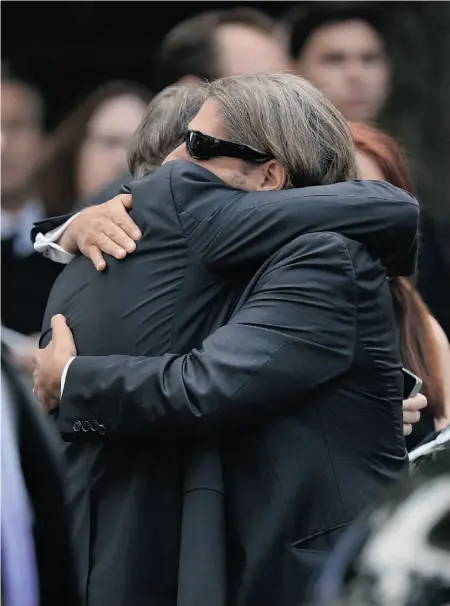  ?? Mike Coppola/getty Images ?? Actors Steve Buscemi, left, and Michael Imperioli embrace at the funeral for their Sopranos colleague, James Gandolfini, at the Cathedral Church of St. John the Divine on Thursday in New York City.