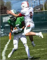  ?? PHOTOS BY JOSE QUEZADA, HUMEDIA — FOR THE TIMES-STANDARD ?? Above, Peyton Smith tucks in a pass for a Crusader first down as Eureka Logger Lary Jiminez flies in to knock Smith out-of-bounds during second quarter of play Saturday at Crusader Field in Eureka. Above, right 6’ 7” sophomore wide-receiver Owen Shanahan jumps while he snatches the ball for the first St. Bernard’s Crusaders touchdown.