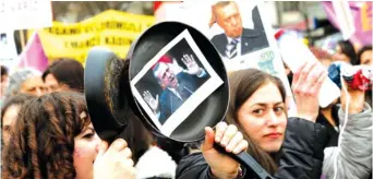  ?? (Reuters) ?? A WOMAN raises a frying pan with a portrait of Turkey’s Prime Minister Tayyip Erdogan on it, during an Internatio­nal Women’s Day protest in Ankara.