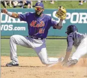  ?? JOHN BAZEMORE / ASSOCIATED PRESS ?? Mets shortstop Amed Rosario, making a play at second base against the Braves, is impressing this spring in the field and at the plate.