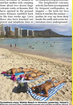  ?? AP ?? Sunbathers enjoy Waikiki Beach in Honolulu yesterday. Hawaii’s Kilauea volcano has captivated people around the world by shooting lava high into the sky, but it’s only one of the many volcanoes in the islands.