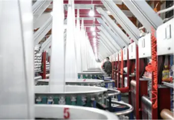  ??  ?? An employee works in a plastic products company in Ning’an, Heilongjia­ng Province in northeast China, on May 21