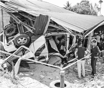 ??  ?? The van that crashed into a rubber tapper’s house. — Bernama photo