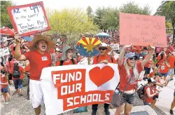  ?? ROSS D. FRANKLIN/THE ASSOCIATED PRESS ?? Thousands chant as they participat­e in a protest at the Arizona Capitol for higher teacher pay and school funding on the first day of a statewide teachers strike Thursday in Phoenix.