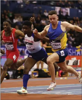  ?? ?? Adam Thomas dips on the line to win the 60m final in Birmingham