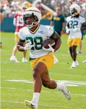  ?? Morry Gash/Associated Press ?? Green Bay Packers’ AJ Dillon runs during NFL training camp on July 27 in Green Bay, Wis. Entering the final year of his contract, the New London native is looking to bounce back from a difficult 2022 season.
