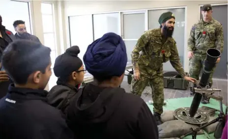  ?? LUCAS OLENIUK PHOTOS/TORONTO STAR ?? Bombardier Mani Bhatti conducts a demonstrat­ion for a group of children at the Sikh Heritage Museum of Canada as part of the exhibit Outwhisker­ed.