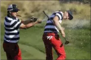  ?? JULIO CORTEZ — THE ASSOCIATED PRESS ?? U.S. Team member Charley Hoffman, left, douses teammate Daniel Berger after he won the final round of the Presidents Cup golf tournament at Liberty National Golf Club in Jersey City, N.J., Sunday.