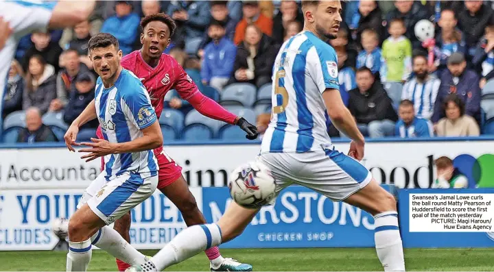  ?? ?? Swansea’s Jamal Lowe curls the ball round Matty Pearson of Huddersfie­ld to score the first goal of the match yesterday PICTURE: Magi Haroun/
Huw Evans Agency