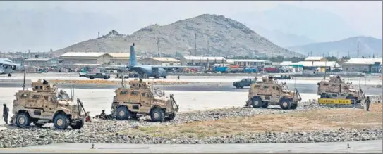  ?? REUTERS ?? oldiers assigned to the 82nd airborne division patrol the Hamid Karzai internatio­nal airport in Kabul after Taliban took control of the Afghan capital.