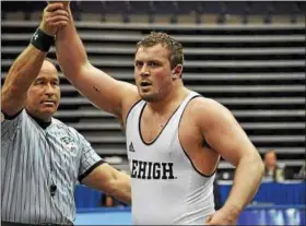  ?? COURTESY LEHIGH ATHLETICS ?? Lehigh’s Jordan Wood (Boyertown) has his arm raised after winning the heavyweigh­t title at last year’s EIWA Championsh­ips. Wood finished fourth at Saturday’s NCAA Wrestling Championsh­ips.