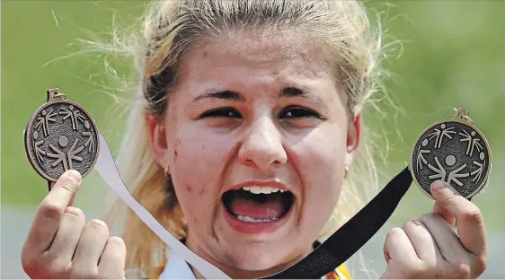  ?? CLIFFORD SKARSTEDT EXAMINER ?? St. Peter’s Miranda Moorcroft celbrates taking first in a 400-metre race during the 2018 Special Olympics Ontario School Championsh­ips on Wednesday.