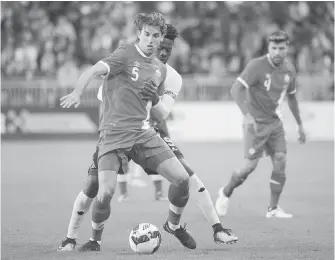  ??  ?? Canada’s Dejan Jakovic holds off a challenge by Jamaica’s Ricardo Morris during the friendly internatio­nal in Toronto on Saturday.