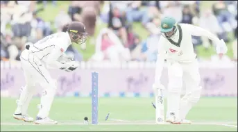  ?? ?? Usman Khawaja is stumped by wicketkeep­er Tom Blundell off the bowling of Glenn Phillips for 28