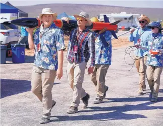  ?? ADOLPHE PIERRE-LOUIS/JOURNAL ?? Auburn University student Ben Creel, left, leads his teammates as they head to the launchpad with their rocket, which was entered in the Spaceport America Cup.