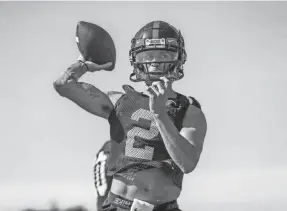  ?? JOSHUA MCCOY/OLE MISS ATHLETICS ?? Ole Miss quarterbac­k Matt Corral throws the ball during the first day of its fall camp Aug. 17 in Oxford, MS. Corral took all the first team snaps as sophomore John Rhys Plumlee missed Saturday’s scrimmage.