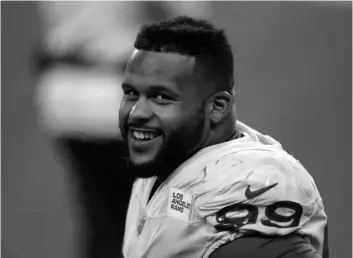  ?? AP Photo/Scott Eklund ?? Los Angeles Rams defensive end Aaron Donald smiles as he stands on the sideline late in the second half of an NFL wild-card playoff football game against the Seattle Seahawks, on Jan. 9 in Seattle.