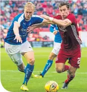  ??  ?? Jon Gallagher takes on Juho Hyvarinen on his Dons debut