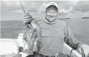  ?? STEVE WATERS/STAFF ?? Dave Bingham shows off half of his six-lobster limit which he caught diving in 8-12 feet of water in the Gulf of Mexico.