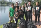  ??  ?? Lee (in green) with volunteers who successful­ly removed more than 18kg of trash from the park.