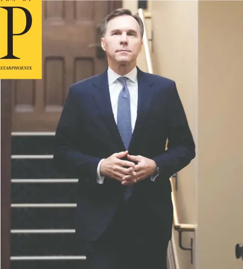  ?? ADRIAN WYLD / THE CANADIAN PRESS ?? Finance Minister Bill Morneau makes his way to the podium to provide a fiscal update in the foyer of Parliament Hill’s West Block on Monday.