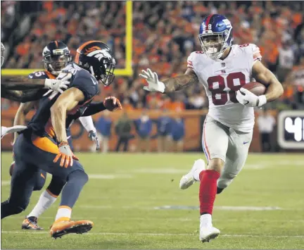  ?? JACK DEMPSEY — ASSOCIATED PRESS FILE ?? In an Oct. 15, 2017, photo, Giants tight end Evan Engram runs upfield after making catch against the Broncos in Denver.