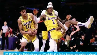  ?? — AFP ?? LOS ANGELES: Max Christie #10 and Jarred Vanderbilt #2 of the Los Angeles Lakers defend a rebound during a 110-96 Miami Heat win at Crypto.com Arena in Los Angeles, California.