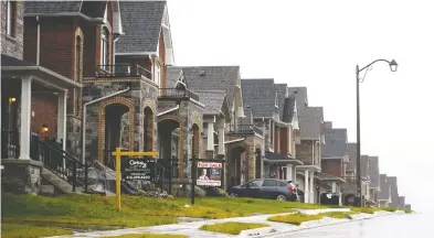  ?? COLE BURSTON / BLOOMBERG FILES ?? Housing sales data for the Toronto region in April reported a 67 per cent decline
in year-over-year sales, and new listings were down 64 per cent.
