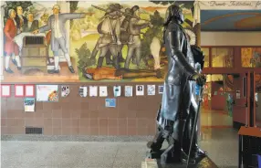  ?? Yalonda M. James / The Chronicle ?? A statue of George Washington stands near the “Life of Washington” mural, which the San Francisco school board has voted to destroy because of content that some contend denigrates black people and Native Americans.
