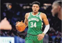  ?? MORRY GASH/ASSOCIATED PRESS ?? The Milwaukee Bucks’ Giannis Antetokoun­mpo brings the ball up the court during Game 5 of their first-round series against Chicago on Wednesday in Milwaukee. The Bucks face Boston in Round 2.